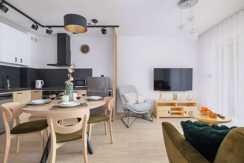 Living room with a sofa bed, Smart TV, kitchenette and access to patio.