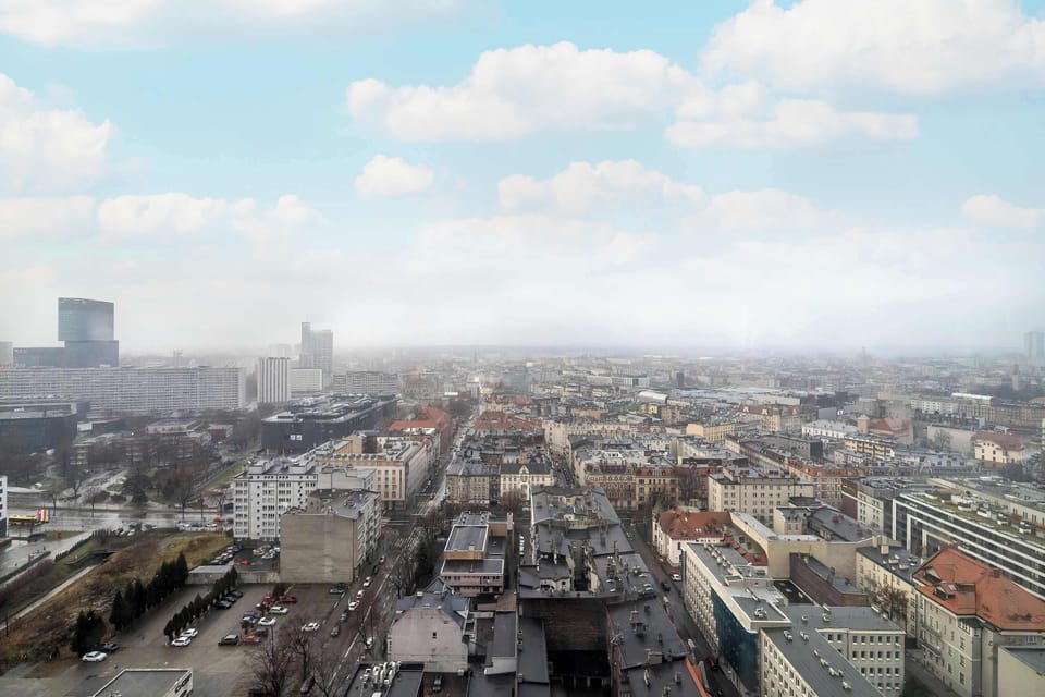 A daytime photo offering a sweeping view of the city from high above.
