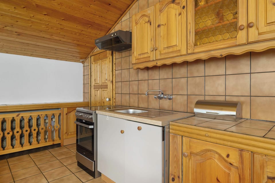 Detailed shot of rustic wooden cabinets and countertops, perfect for showcasing craftsmanship in a traditional kitchen design.