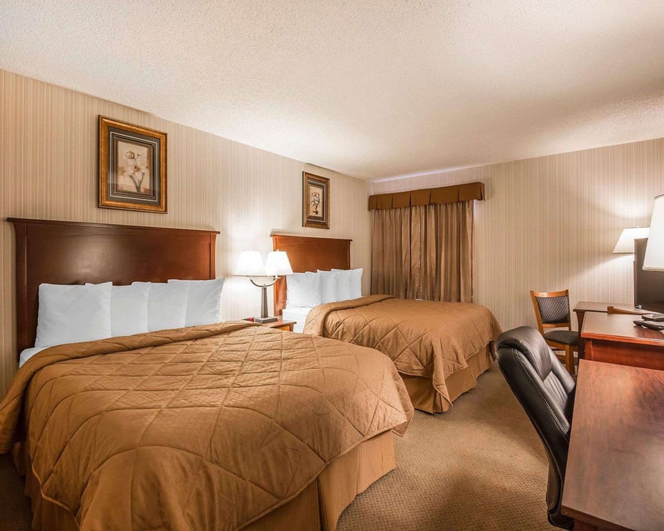 Pillowtop beds, desk, blackout drapes, iron/ironing board