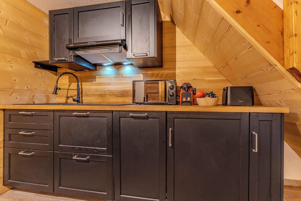 Modern Fully-Equipped Kitchen Cook up hearty dishes in a sleek kitchen that blends functionality with alpine charm — ideal for family getaways.