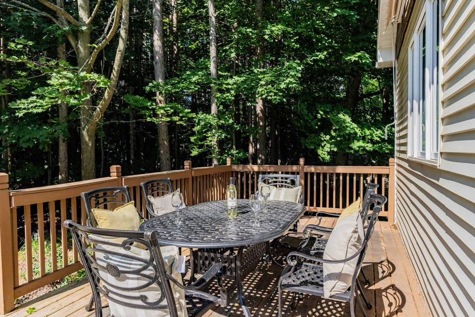 Deck with outdoor dining table and gas grill