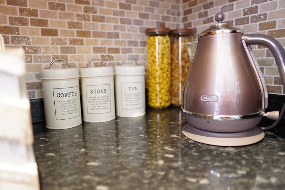 Kitchen essentials ready for guests: kettle, tea, coffee and sugar. ☕✨