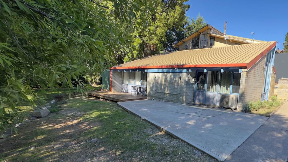 Exterior - deck with chairs and table, parking spaces
