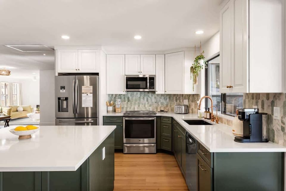 Fully equipped kitchen with stainless steel appliances, a kitchen island, and an informal dining area with seating for 5.