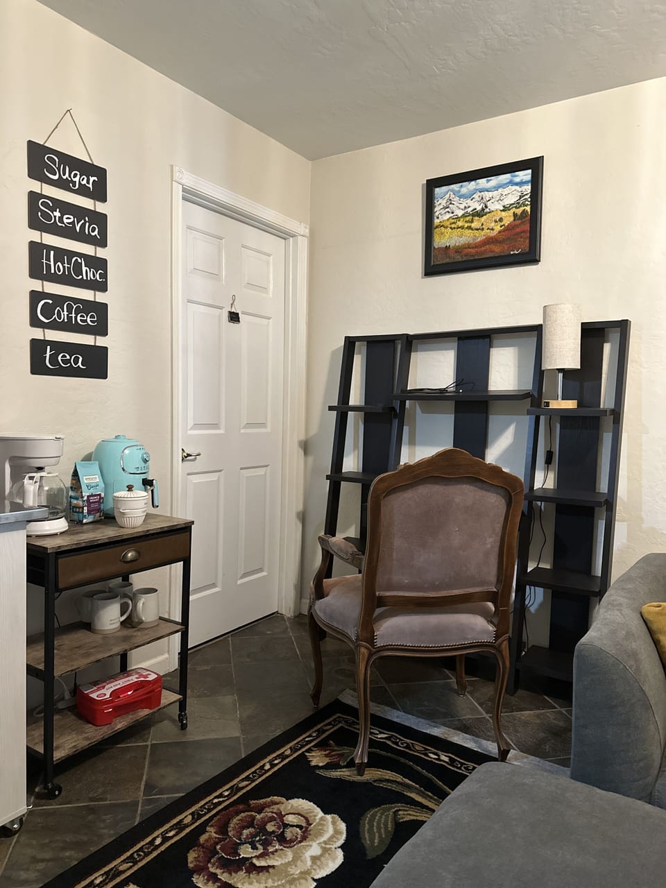 A coffee and tea spot next to a work space for your laptop /phone charging light