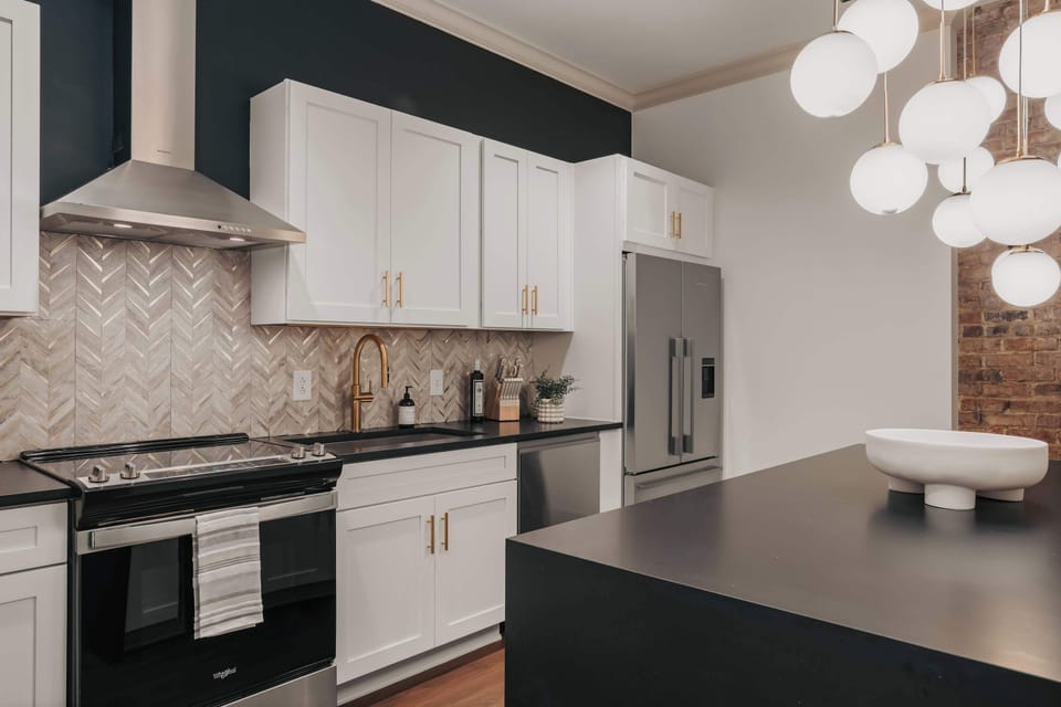 The modern kitchen is fully equipped with stainless steel appliances and thoughtfully stocked with everything you need to cook.