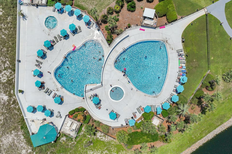 TWO LARGE POOLS overlooking the Gulf of Mexico (1 heated during cooler months) with tons of lounge chairs, Waterfall Feature, 1 Hot Tub, 1 Kiddie Pool, and Seasonal Tiki Bar