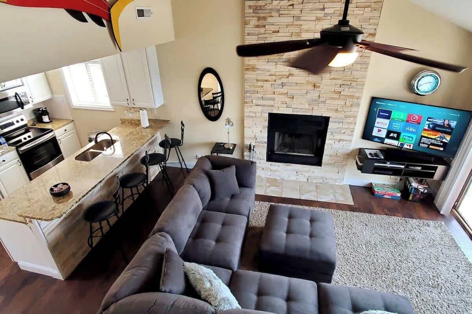 Open kitchen and breakfast counter with oversized "L" sectional.