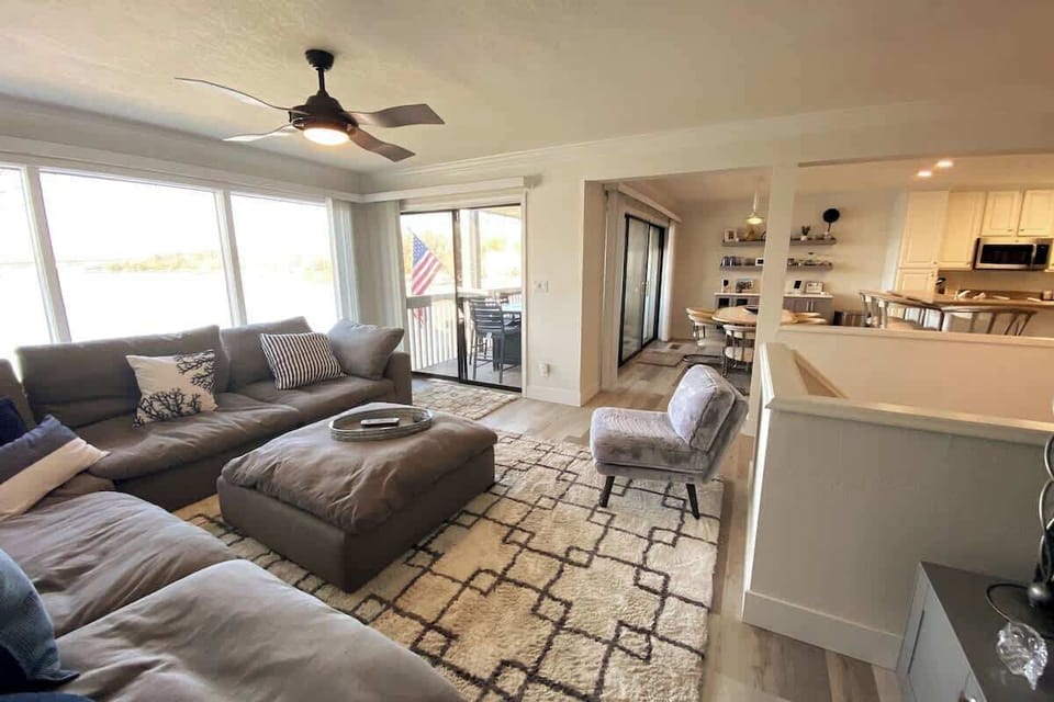 Large open LR, DR, bar, and kitchen. Wall to wall windows.  Two sets of patio doors going to Patio. The couch is so comfy, that guests have literally inquired where we purchased it from.  