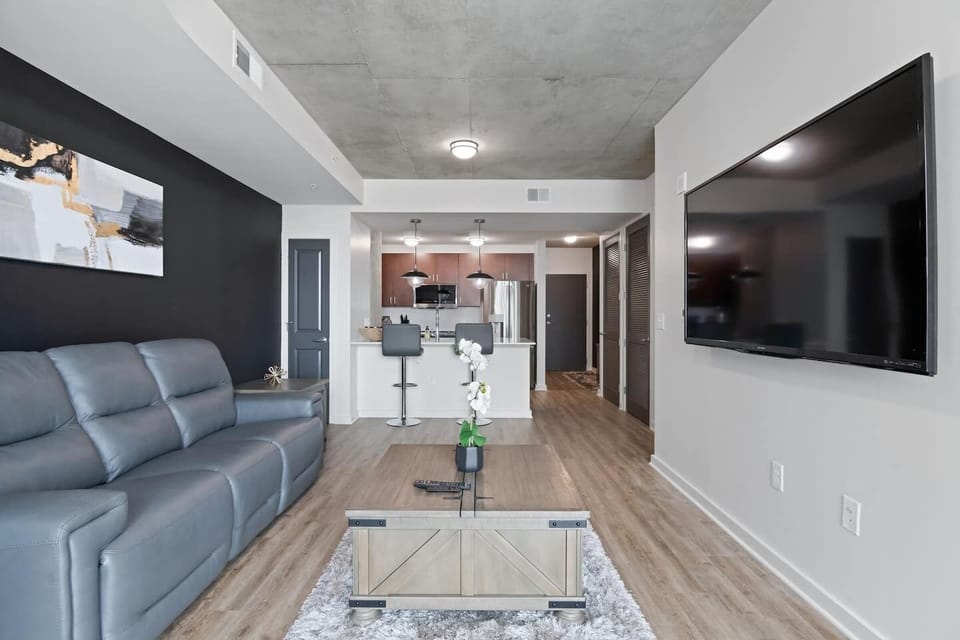Relax in our spacious living room, complete with stylish furnishings and a large flat-screen TV. Whether you're unwinding with a movie night or hosting friends, our cozy yet modern space provides comfort and entertainment throughout your stay.