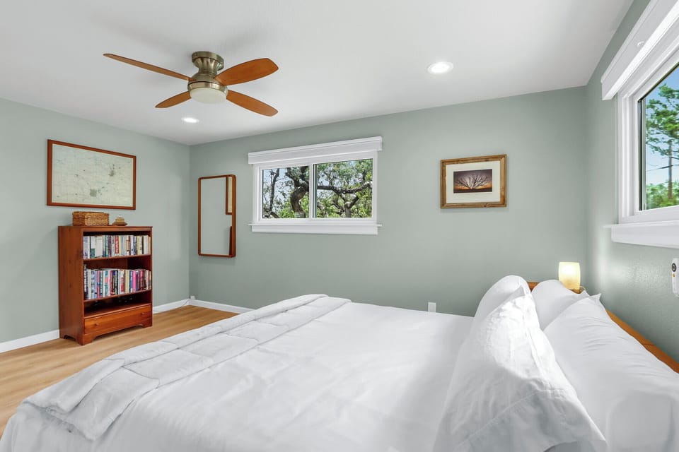 Bedroom 2 offers more views of the property’s many live oak trees