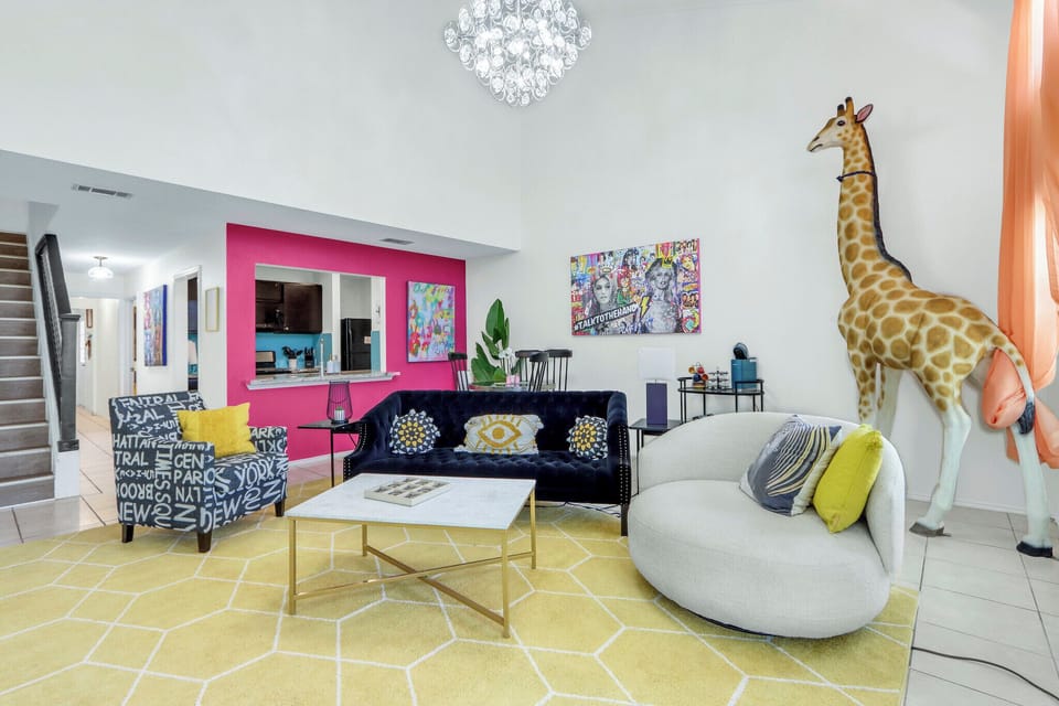 The living room is in front of the dining area
