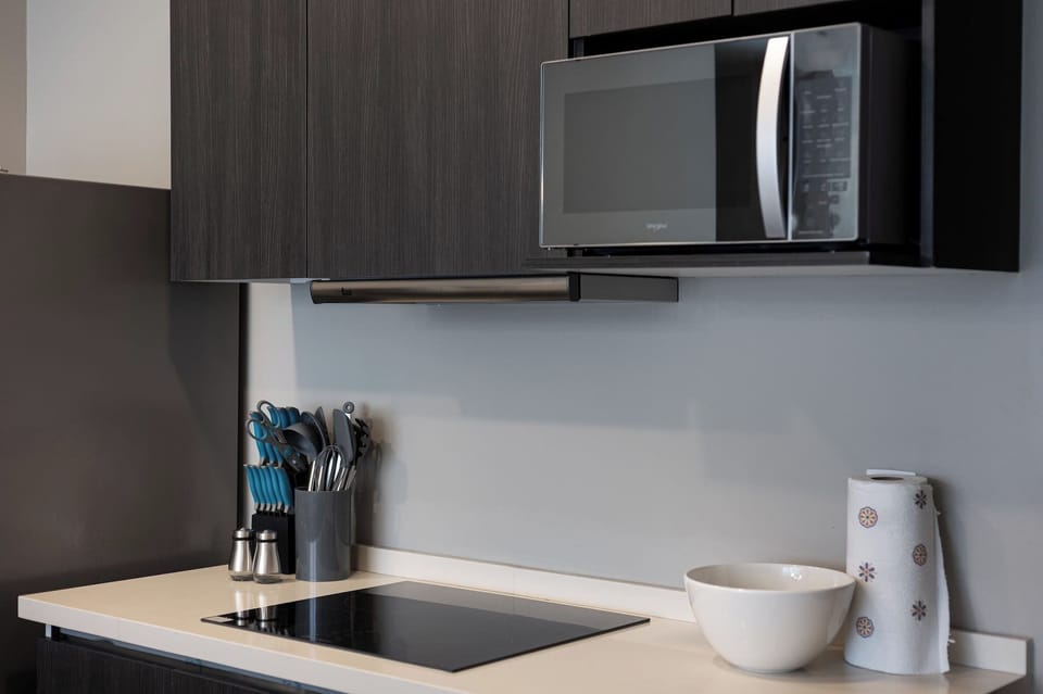 Kitchen detail featuring a built-in microwave and electric glass cooktop.