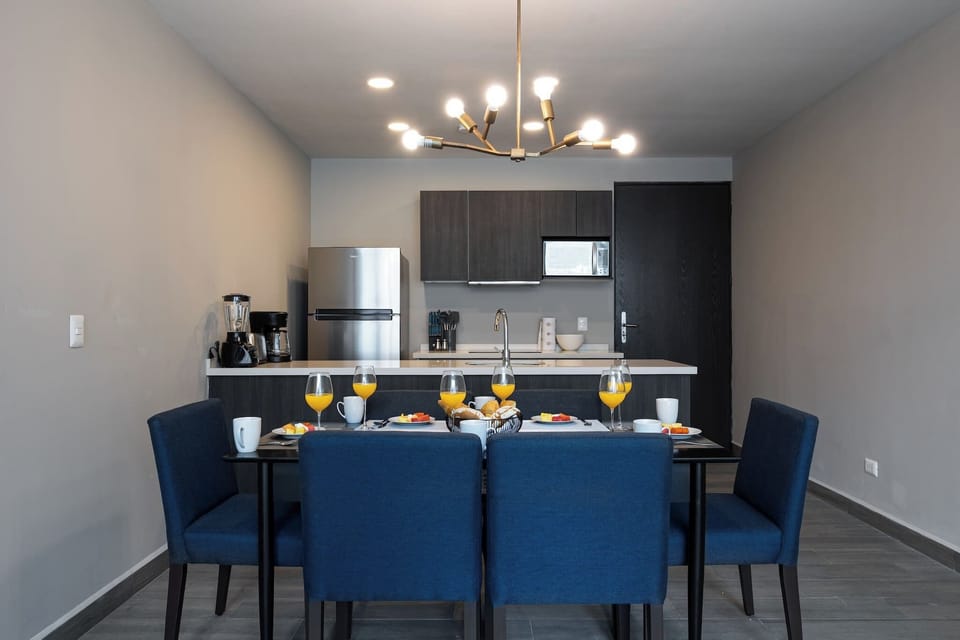 Cook, dine, and connect in a modern open kitchen and dining space.