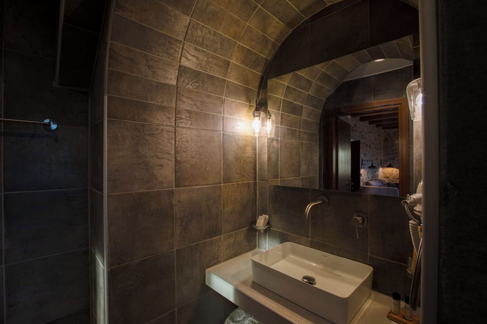 Anemos Tower Suite | Bathroom | Separate tub and shower, hair dryer, slippers, towels