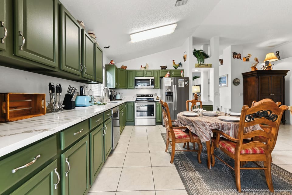Kitchen Area with Refrigerator, Microwave oven, Stove, Coffee Maker, Electric Kettle, Kitchen utensils, and Kitchenwares