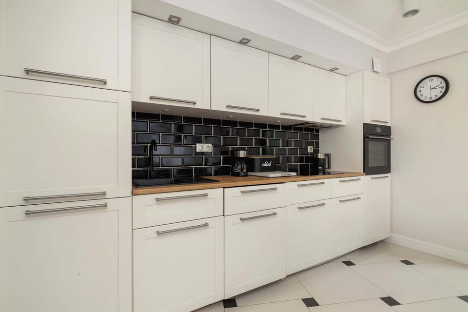 The kitchenette's sleek design includes all necessary cookware and utensils.