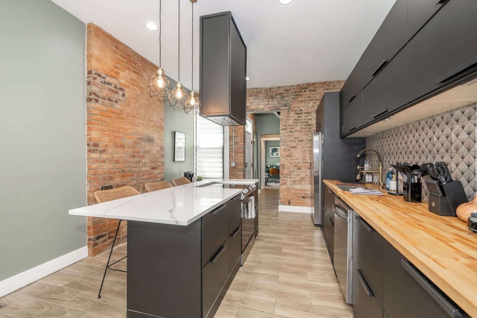 The sleek, modern kitchen offers ample space & every home comfort​