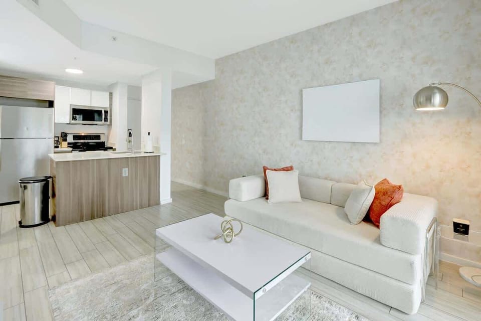 Spacious living room with cozy seating and a 65" smart TV, perfect for movie nights or relaxing after a day out.
