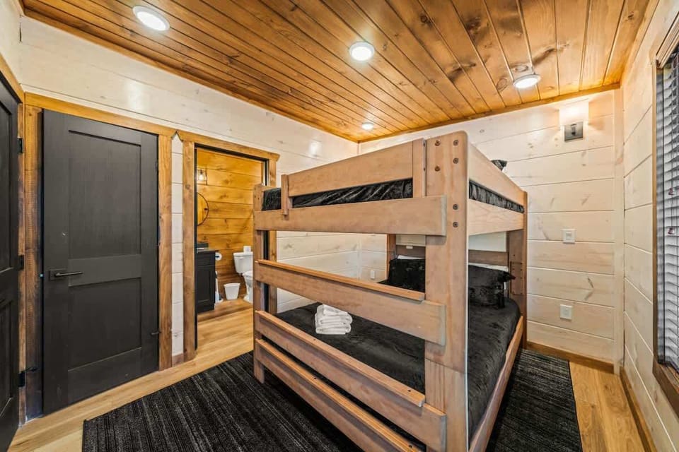 Queen over queen bunk room Third king suite located on the upper level with clothing storage, smart TV, ceiling fan, closet, and ensuite full bathroom.