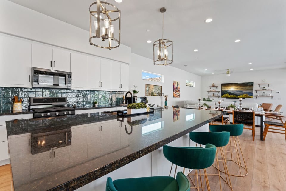Sleek kitchen w/ long island, bar seating & modern finishes for easy entertaining