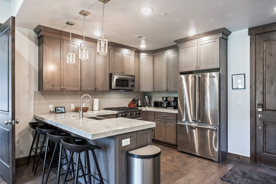 - Cook with ease in the fully equipped kitchen with stainless appliances  
- Granite counters and bar seating perfect for casual dining  
- Modern lighting adds warmth to your culinary space
