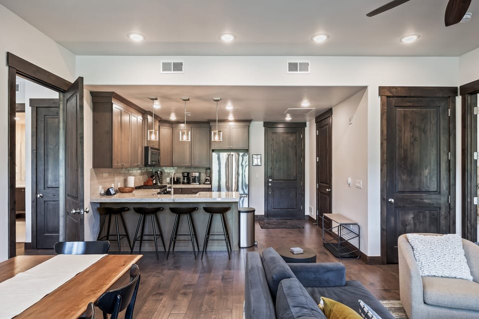 - Dining area flows into open concept kitchen space  
- Granite countertops and bar seating for casual meals  
- Bright lighting and wood finishes add modern charm