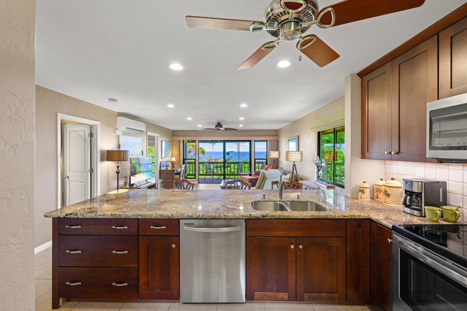 Built-in stainless steel dishwasher makes cleanup easy after meals.
