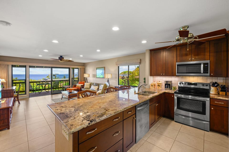 Large kitchen with granite countertops and open layout, ideal for cooking and entertaining.