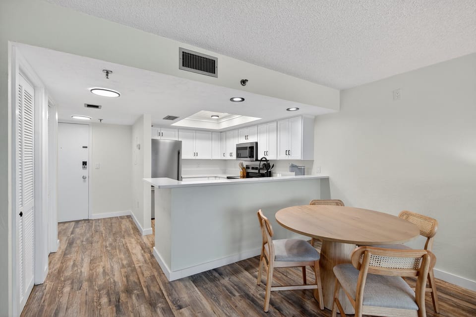 Gather for meals or game night at the dining table with seating for four, conveniently located next to the beautifully updated kitchen