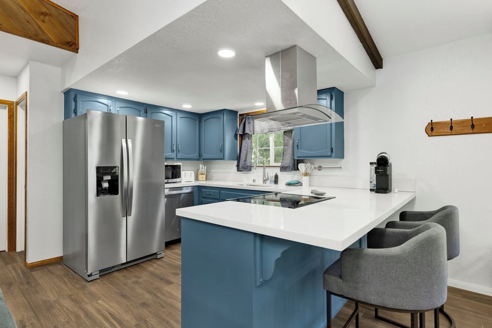 Fully equipped cabin kitchen with ample cabinetry, stove, fridge, microwave, and coffee maker—perfect for cooking meals, morning coffee, and feeling right at home on your stay.