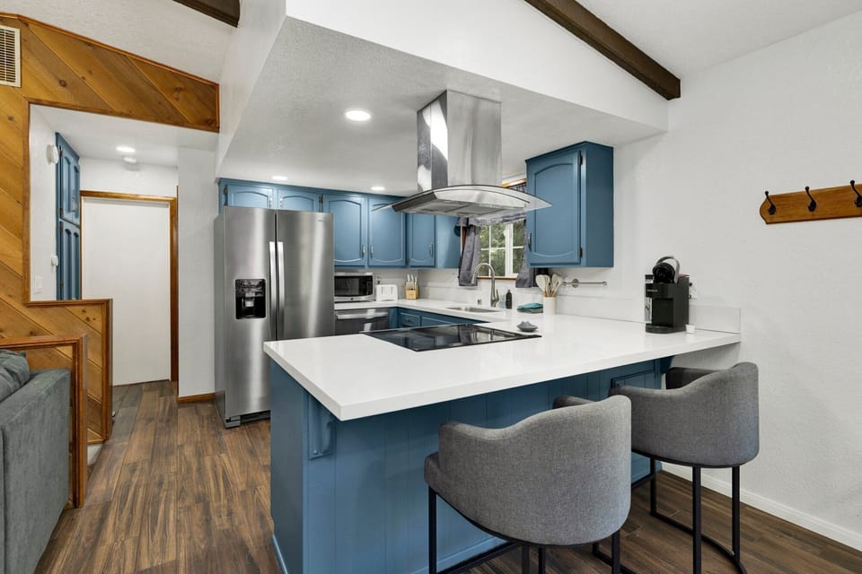Fully equipped cabin kitchen with ample cabinetry, stove, fridge, microwave, and coffee maker—perfect for cooking meals, morning coffee, and feeling right at home on your stay.