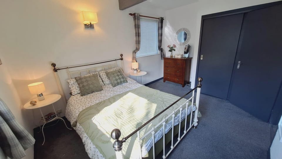 Master bedroom with King sized bed, side tables with lamps, chest of drawers, built in wardrobe and en-suite bathroom.