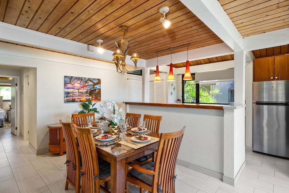 Comfortable dining area with natural wood tones and a bright, airy connection to the kitchen