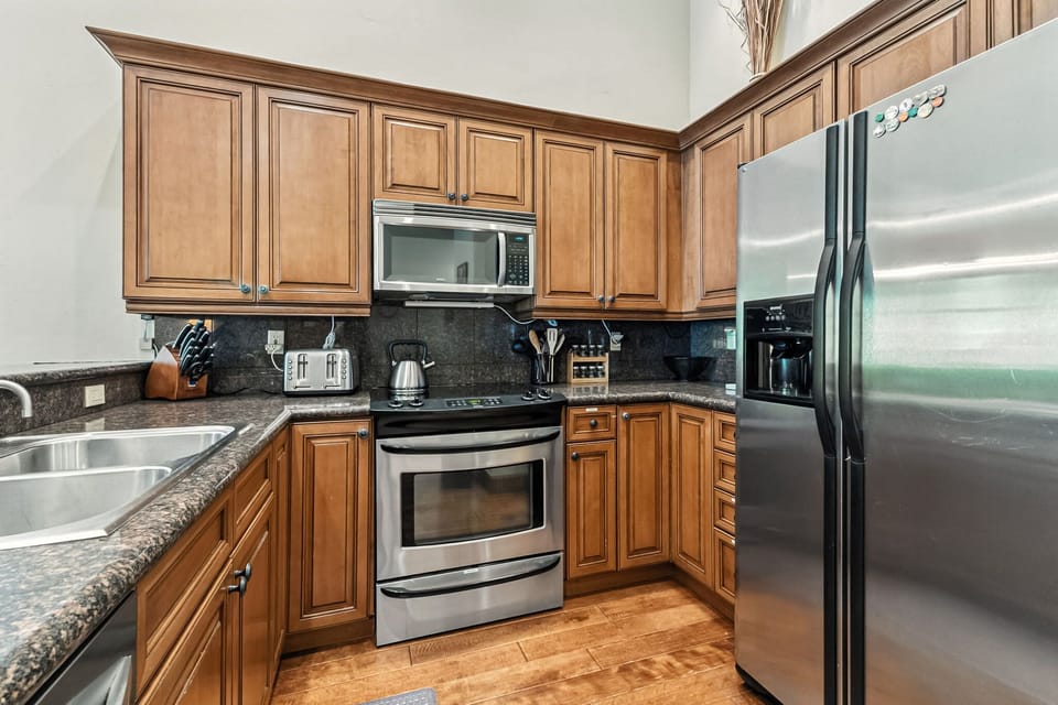 Kitchen: Main floor, drip coffee maker, Keurig, toaster, cooking utensils, tableware