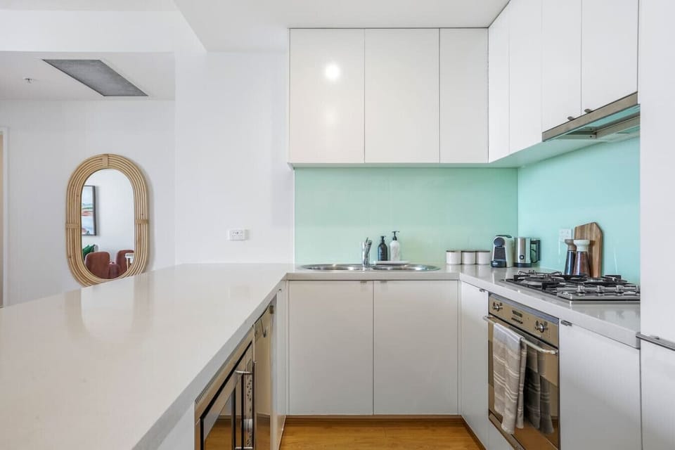 A clean, modern kitchen with sleek cabinetry, ample counter space, and essential appliances, offering a bright and functional area for easy meal preparation.