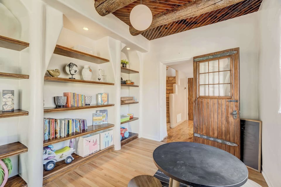 Explore endless adventures in our dedicated kid's space, complete with a cozy table, bookshelf stocked with books, and a treasure trove of toys for little ones to enjoy.