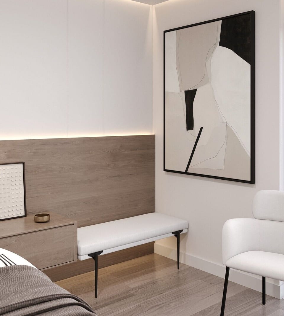 Sip morning coffee beside minimalist art and cozy seating.