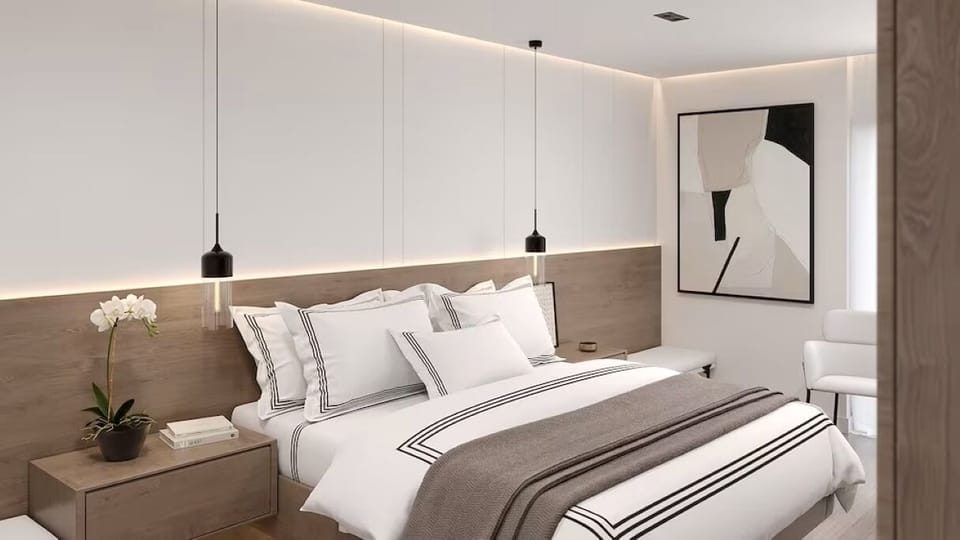 Unwind into crisp linens beneath soft, calming ambient lighting.