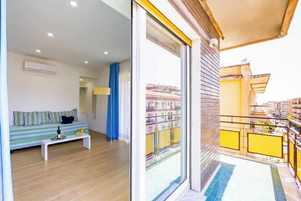 Deluxe Triple Room, Balcony, City View | Desk, laptop workspace, blackout drapes, iron/ironing board