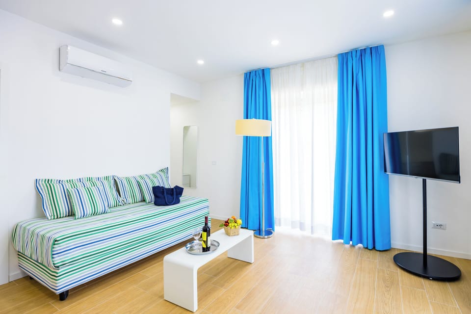 Deluxe Triple Room, Balcony, City View | Desk, laptop workspace, blackout drapes, iron/ironing board