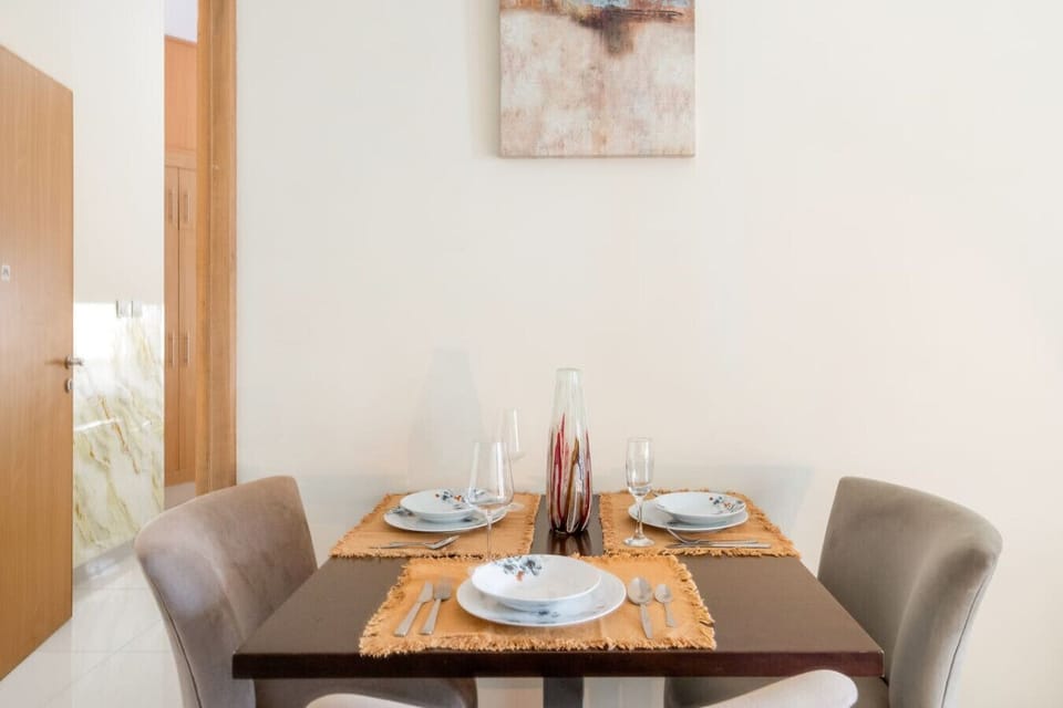 Dining Area: Savor meals in style at this elegantly set table, perfect for shared moments!