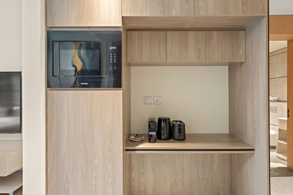 Kitchenette: Sleek design meets functionality with high-end appliances for your culinary adventures!