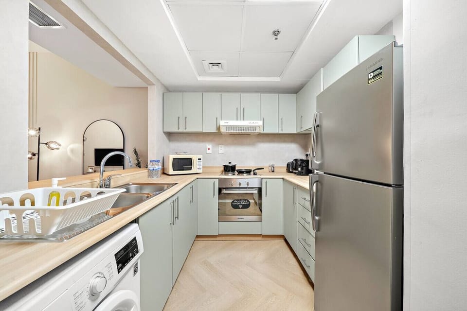 Kitchen: Modern appliances and sleek design make cooking a delight in your Dubai getaway!
