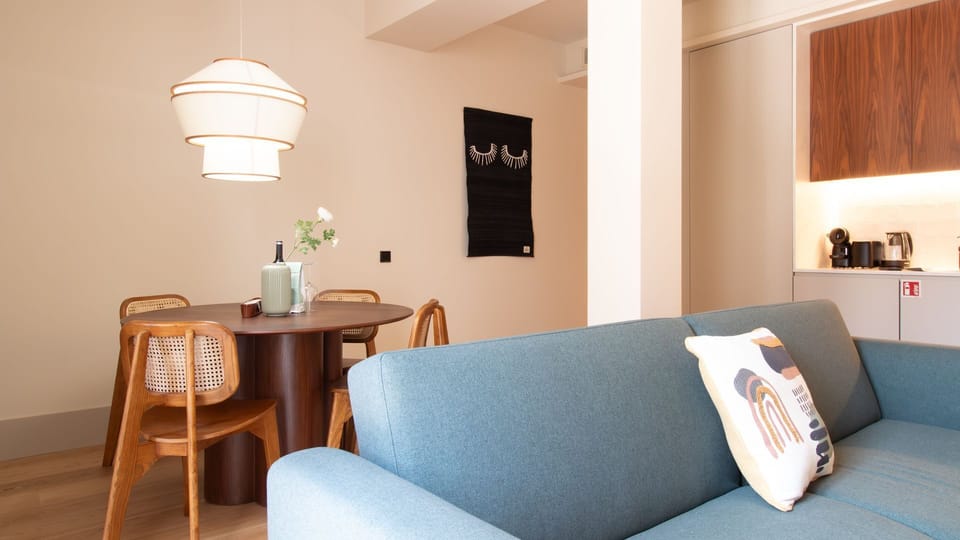 Mid-century charm meets modern coziness in this inviting dining nook—ideal for wine, conversation, or remote work. #DiningCorner #DesignDetails #LovelyStay