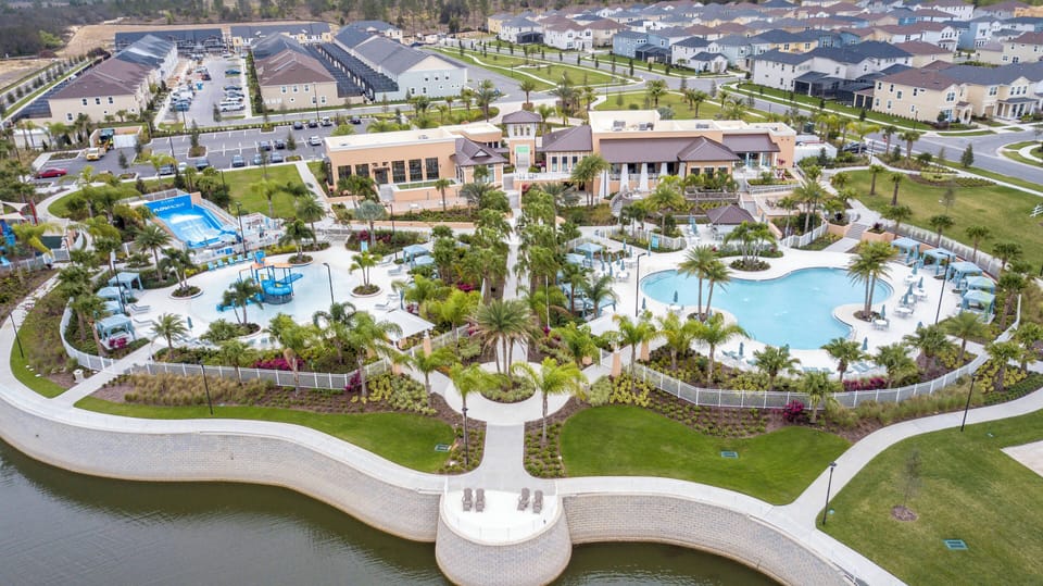 Experience a vibrant outdoor oasis with stunning gardens and sparkling pools. Relax on the loungers as sunlight glistens on the water, and enjoy a refreshing drink in this inviting space designed for your leisure and fun.