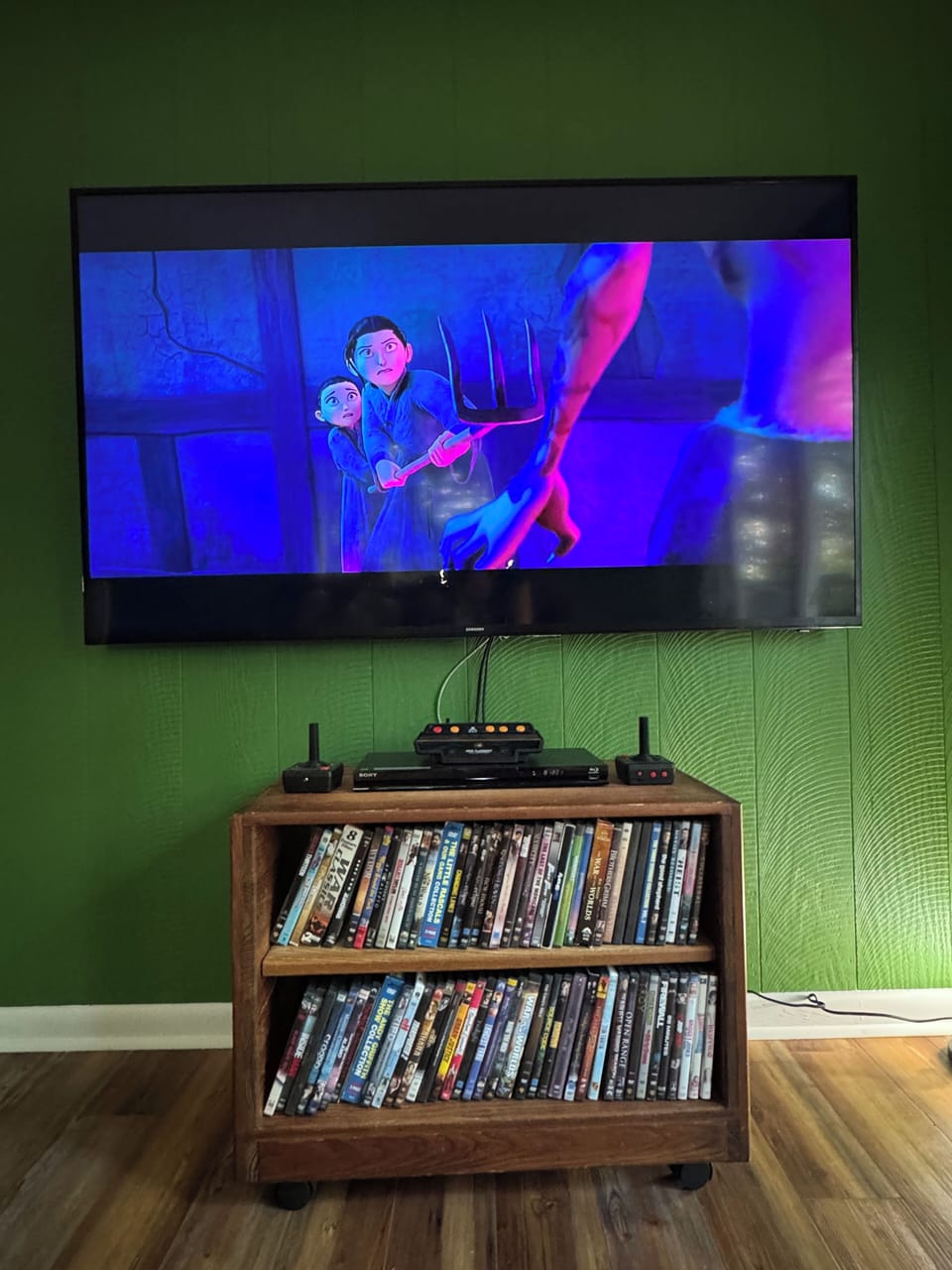 Downstairs movie area with smart TV,  DVD player, and retro Atari