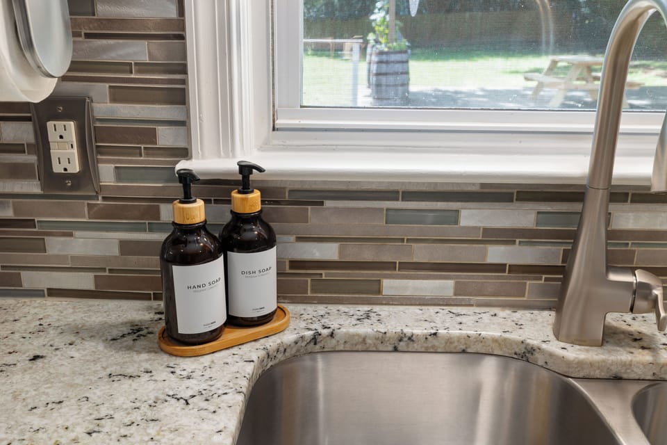Centrally located for convenience, the kitchen sink access for prep and rinse