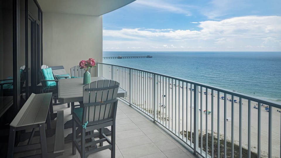 Enjoy meals or drinks on your spacious balcony, featuring comfortable seating and beautiful views of the shoreline